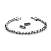 The WALI - Polished bracelet by Armor of the Free is shown open with two small strap clasps inside its sleek silver circular shape, all set against a white background.