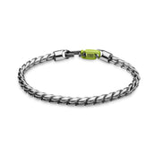 The WALI - Polished bracelet by Armor of the Free is a silver twisted chain with a clasp, featuring a strap-inspired design and a small green tag labeled ARMOR OF FREE near the fastening.